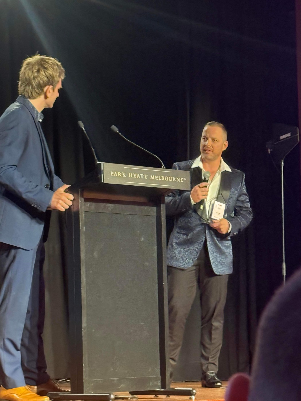 Luke Tadich accepting the Young Entrepreneur of the Year award on stage